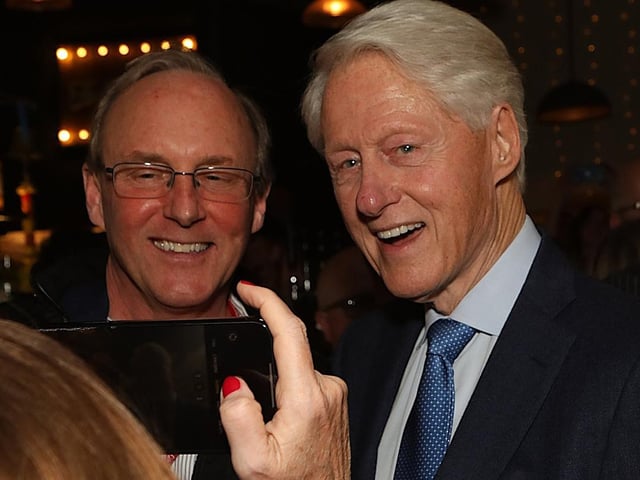 Bill Clinton stops for a photograph in the Taphouse.