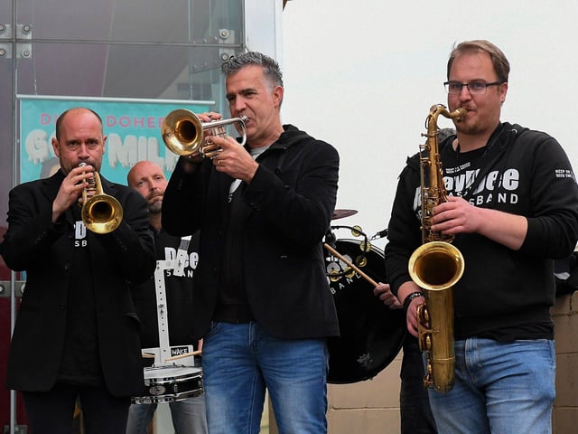 Daan Bogers, Joep Habraken and Sam Thomas Jaydee Brass Band members outside the Millennium Forum on Friday evening. Photo: George Sweeney