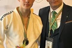 Konarakai Judo Club's bronze medal winner, Shane Gallagher, celebrates with coach Paul Green in Port Elizabeth.