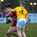Antrim's  Eoghan O'Hare grapples with Derry's  Ryan McNicholl. Photo: George Sweeney