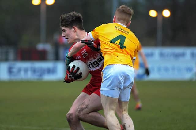 Antrim's Eoghan O'Hare grapples with Derry's Ryan McNicholl. Photo: George Sweeney