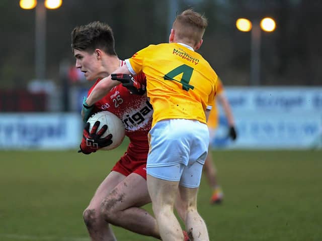 Antrim's  Eoghan O'Hare grapples with Derry's  Ryan McNicholl. Photo: George Sweeney