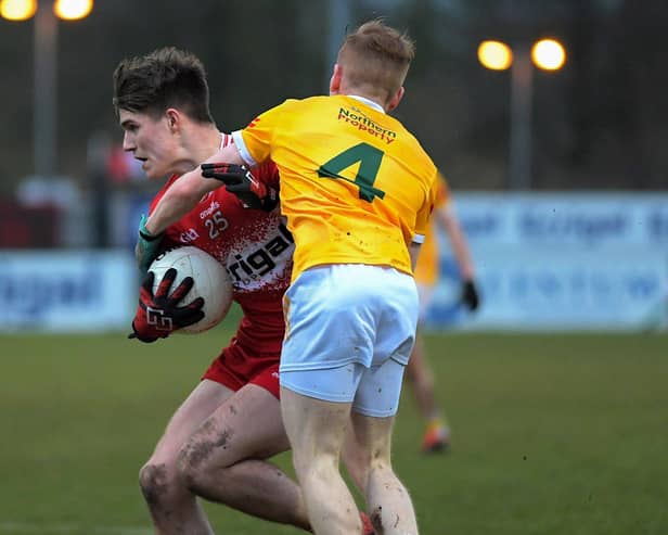 Antrim's  Eoghan O'Hare grapples with Derry's  Ryan McNicholl. Photo: George Sweeney