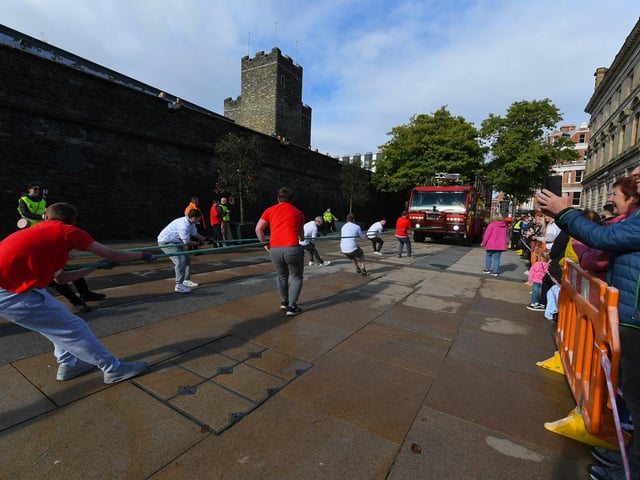 One of the fundraising teams pulls a 32-tonne City of Derry Airport Fire and Rescue Engine, in Guildhall Square, in aid of Children In Crossfire. Photo: George Sweeney