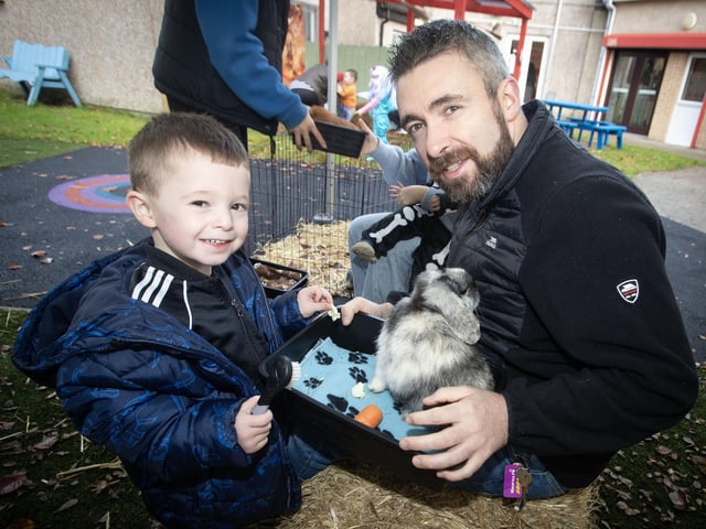 Christopher and his dad feeding one of the rabbits at CPTT (Creggan) last week.