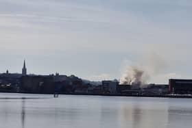 Smoke billowing from the Queen's Court building on Monday.
