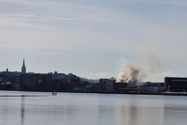 Smoke billowing from the Queen's Court building on Monday.