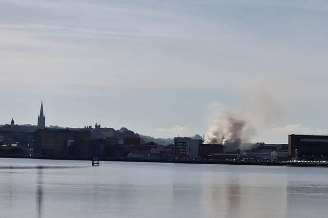 Smoke billowing from the Queen's Court building on Monday.