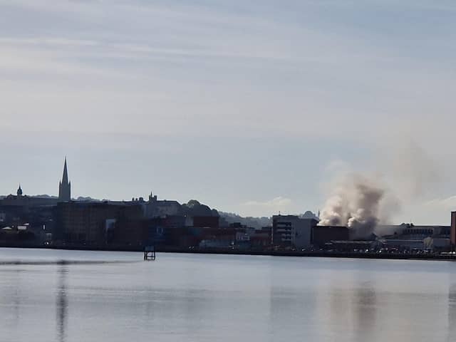 Smoke billowing from the Queen's Court building on Monday.