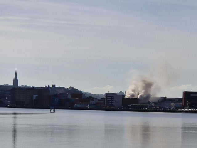 Smoke billowing from the Queen's Court building on Monday.