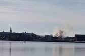 Smoke billowing from the Queen's Court building on Monday.