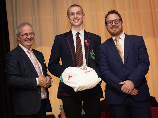 Bobby Skeggs, Head Boy, accepts an award from Mr. John Harkin, Principal and Mr. Sean Pettis, guest speaker on Thursday last.