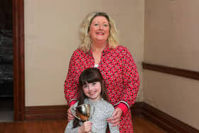 Oonagh Caldwell and her niece Robyn pictured with the Fr. Adrain Porter Perpetual Cup, won for the third consecutive year by the Hannigan Sing School at the Feis Dhoire Cholmcille on Friday at St Columb’s Hall. Photo: George Sweeney.