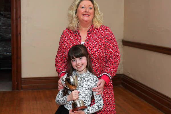 Oonagh Caldwell and her niece Robyn pictured with the Fr. Adrain Porter Perpetual Cup, won for the third consecutive year by the Hannigan Sing School at the Feis Dhoire Cholmcille on Friday at St Columb’s Hall. Photo: George Sweeney.