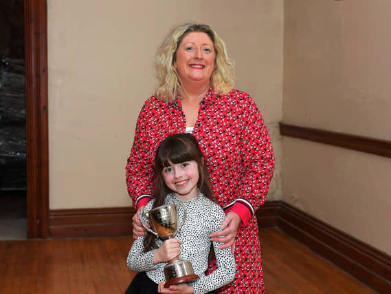 Oonagh Caldwell and her niece Robyn pictured with the Fr. Adrain Porter Perpetual Cup, won for the third consecutive year by the Hannigan Sing School at the Feis Dhoire Cholmcille on Friday at St Columb’s Hall. Photo: George Sweeney.
