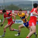 Derry’s Paul Cassidy is challenged by Clare’s Dermot Coughlan at Owenbeg on Sunday afternoon.  Photo: George Sweeney. DER2312GS – 02