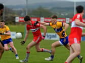 Derry’s Paul Cassidy is challenged by Clare’s Dermot Coughlan at Owenbeg on Sunday afternoon.  Photo: George Sweeney. DER2312GS – 02