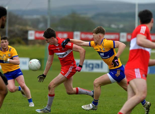 Derry’s Paul Cassidy is challenged by Clare’s Dermot Coughlan at Owenbeg on Sunday afternoon.  Photo: George Sweeney. DER2312GS – 02