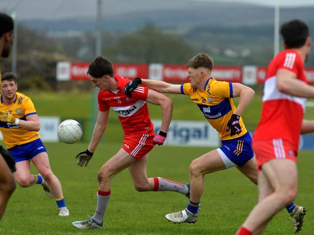 Derry’s Paul Cassidy is challenged by Clare’s Dermot Coughlan at Owenbeg on Sunday afternoon.  Photo: George Sweeney. DER2312GS – 02