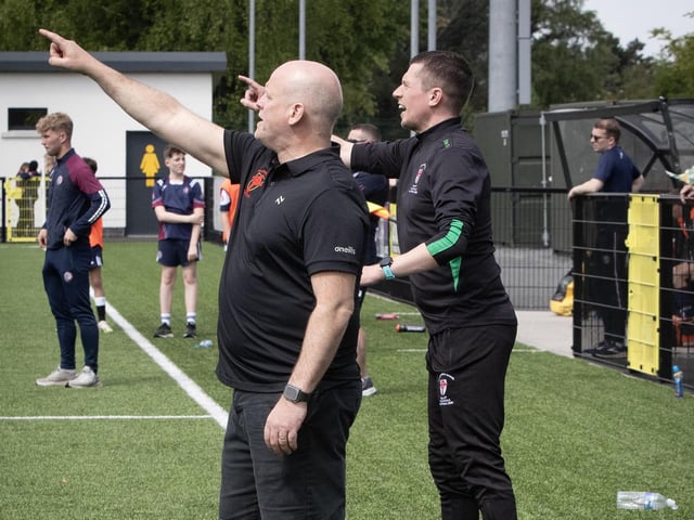 St. Joseph's coaches Paul Gibbons and Emmett McGinty getting their backline organised in the dying minutes of Thursday's final.