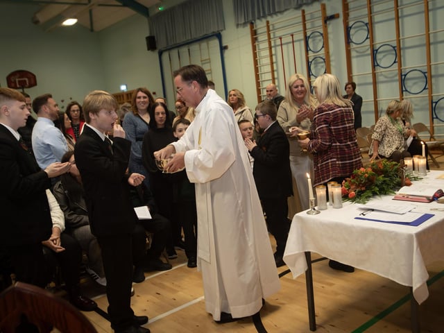 Staff, students and parents receiving First Holy Communion at Thursday evening's Mass in St. Joseph's Boys School.