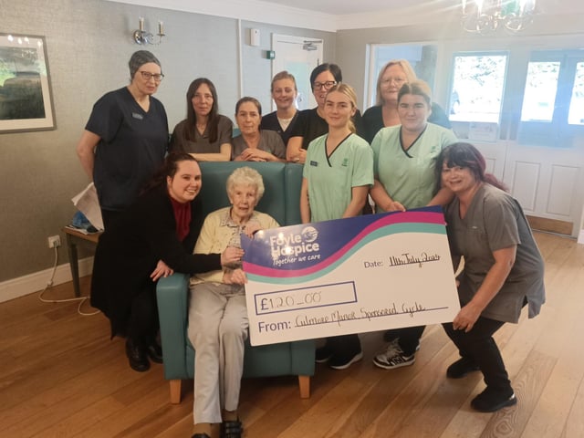 Staff and Residents of Culmore Manor Care Centre pictured with a cheque for £120 in aid of Foyle Hospice, proceeds from a recent 8-hour Cycleathon.