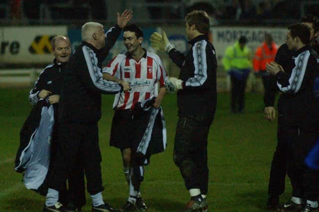 Derry City manager Gavin Dykes congratulates goalscorer Mark Farren as he leaves the pitch at Brandywell.