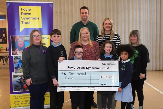 Ashlea Primary and Nursery School presented a £100,collected by pupils, to Foyle Down Syndrome Trust this week. Pictured are Eve, Foyle Down Syndrome Trust, pupils Rogan, Will, Katherine and Perrie, and Laura, Foyle Down Syndrome Trust. Included in the picture are Christopher Cooper, manager Foyle Down Syndrome Trust, Mrs A. Burke, principal and Miss R. Cummings, teacher. Photo: George Sweeney