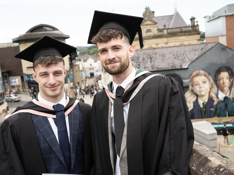 Renewable Energy Engineering graduates Reece Irvine (left) and Stuart Lecky (right), from Ballymena, graduate from Ulster University in Derry on Monday July 8.  (Photo: Nigel McDowell / Ulster University)