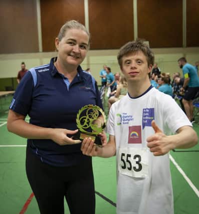 Young Benjamin Thompson with Aisling Hutton from the Bogside & Brandywell Health Forum after Sunday's 'Try-a-Tri' event in Templemore.