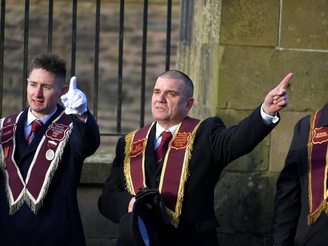 Graeme Stenhouse, Governor ABOD, (centre) take a salute during the Apprentice Boys of Derry’s Shutting of the Gates 336th commemoration held in the city on Saturday. Photo: George Sweeney