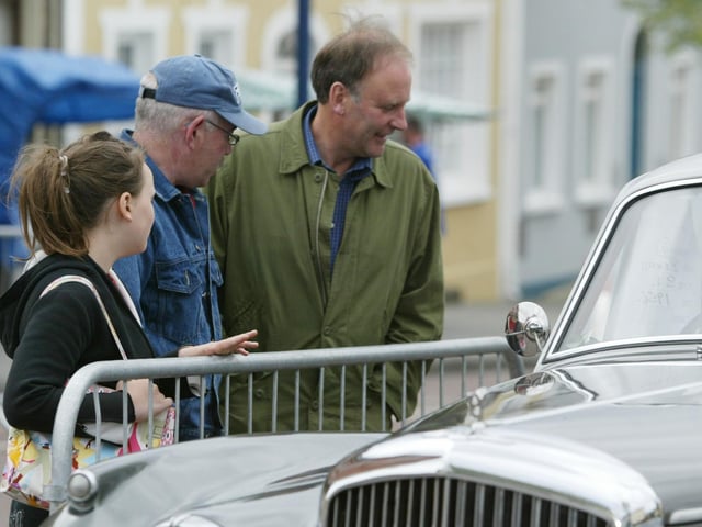 Martha Guiney, Tommy Canning and Lawrence Guiney admire one of the Bentleys on display at the 30th Vintage Rally in Moville in 2004. (0607JB18)