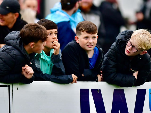 These young lads have a pre-match discussion pitchside.