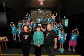 Ollie Green, from Studio 2, and Geraldine Dougan (centre), from Radius Housing Association, pictured with some of the children and volunteers from across the community who participated in the week long Good Relations, arts based, Summer Camps held at Studio. Photo: George Sweeney