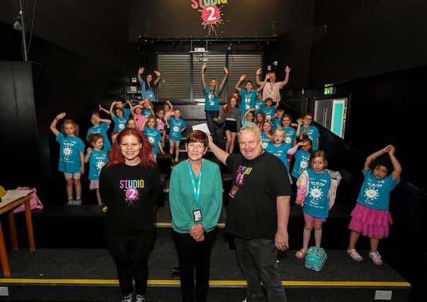 Ollie Green, from Studio 2, and Geraldine Dougan (centre), from Radius Housing Association, pictured with some of the children and volunteers from across the community who participated in the week long Good Relations, arts based, Summer Camps held at Studio. Photo: George Sweeney