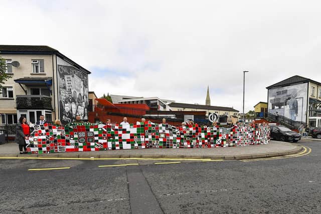 Granny Squares for Gaza quilt outside the Museum of Free Derry on Tuesday. The quilt stretches over 40 metres, comprising of 2300 squares each representing 10 children murdered by Israel in Gaza. Mayor Ruairí McHugh, Tony Doherty, Chair of the Bloody Sunday Trust, Ciara Ferguson MLA, and local councillors Emma McGinley and Christopher Jackson took part in displaying the quilt outside the Museum. Photo: George Sweeney