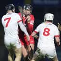 Derry's Meehaul McGrath breaks through Tyrone duo Tiernan Morgan and Seamus Sweeney last week.