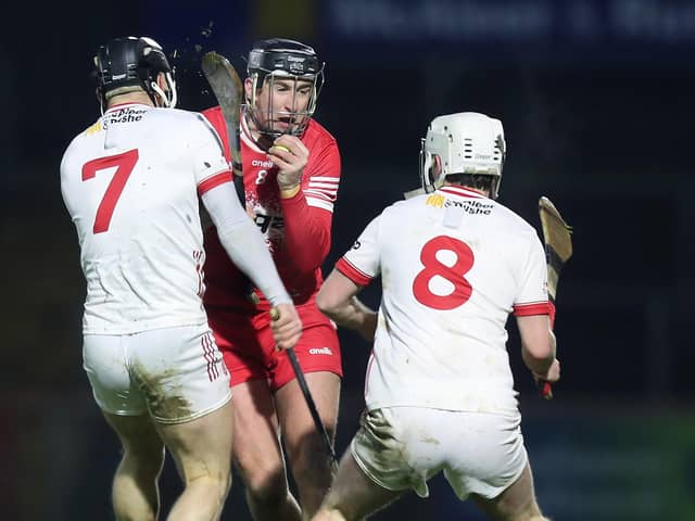 Derry's Meehaul McGrath breaks through Tyrone duo Tiernan Morgan and Seamus Sweeney last week.