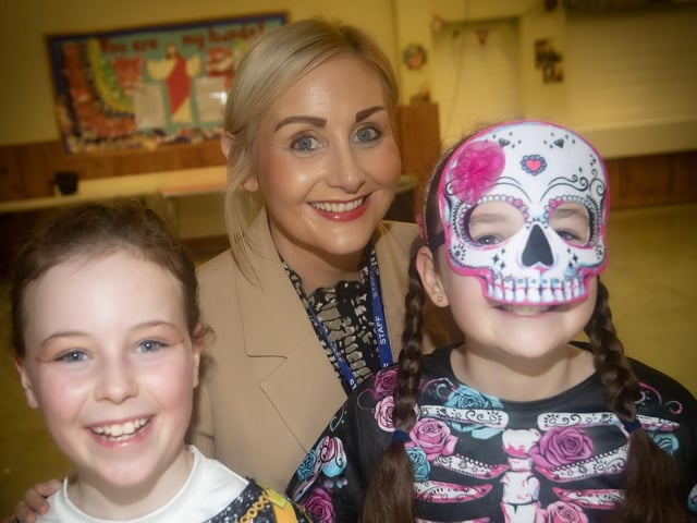 Mrs Houston finds a couple of spooky characters lurking in the hall at Hollybush PS on Wednesday. : .