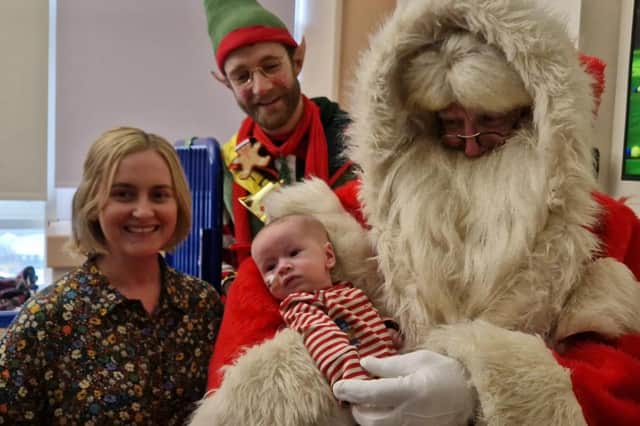 Little Jamie Harkin (four months) and his mother Rachel from the Hatmore area with Santa and one of his elves at Altnagelvin Hospital in Derry on Thursday.