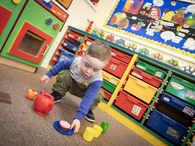This young man takes to making some tea and cake during his visit to the Nursery Class at Monday's Open Day at the Model PS : .