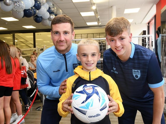 Derry City stars Patrick McEleney and Ciaron Harkin picured with one of the youngsters who enjoyed meeting them at the O'Neills Superstore on Tuesday.