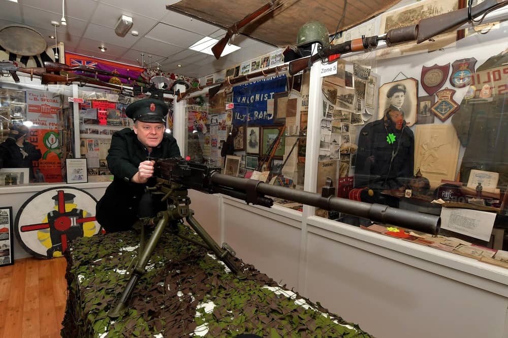 Gary McNicholl, proprietor of the Bedlam Museum on Derry’s  Shipquay Street pictured with a WW II Breda M37 Italian Medium machine gun. Photo: George Sweeney