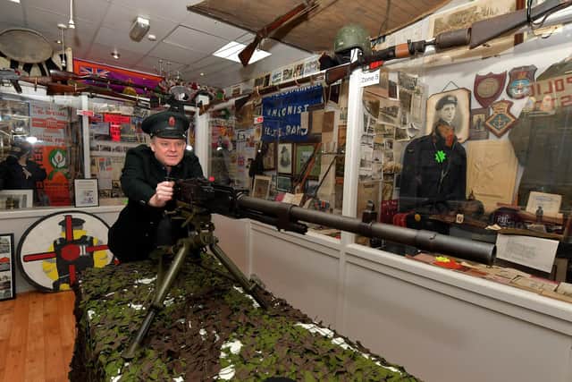 Gary McNicholl, proprietor of the Bedlam Museum on Derry’s Shipquay Street pictured with a WW II Breda M37 Italian Medium machine gun. Photo: George Sweeney