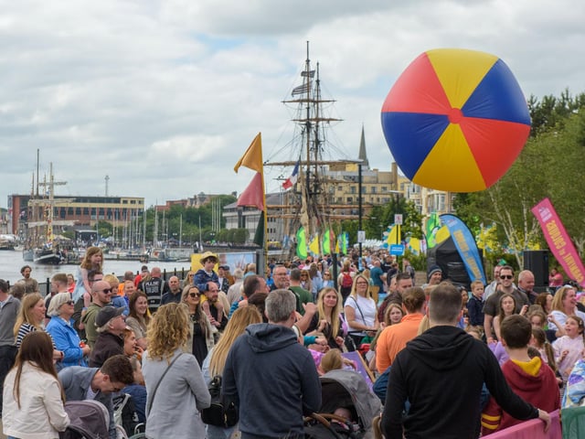 A giant beach ball rises over the crowd during a game of “keepy uppy”,  at Derry City and Strabane District Council’s Foyle Maritime Festival which has brought thousands of visitors to the riverside in the city over the weekend. Picture Martin McKeown. 29.06.24
