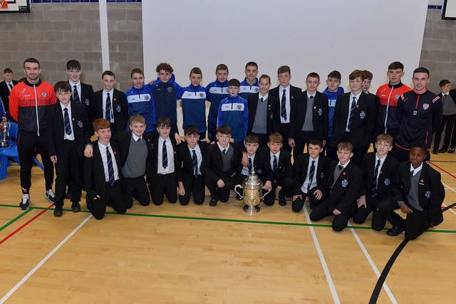 Derry City players Michael Duffy, Liam Mullan and Jordon McEneff pictured with St Columb's College Year 9 pupils during a visit to the school, with the FAI Cup, on Monday. Photo: George Sweeney. DER2247GS - 23