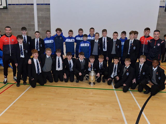 Derry City players Michael Duffy, Liam Mullan and Jordon McEneff pictured with St Columb's College Year 9 pupils during a visit to the school, with the FAI Cup, on Monday. Photo: George Sweeney. DER2247GS - 23
