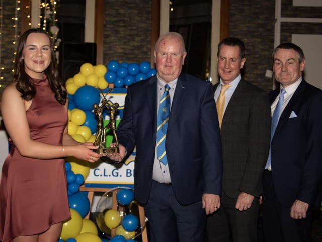 Leah Gallagher, Senior Camogie Player of the Year 2024, receives her trophy from Liam Gallagher, Club Chair. Included on right are Cormac Hartnett, County Board Hurling Officer and Ciaran McLaughlin, Outgoing Ulster President.