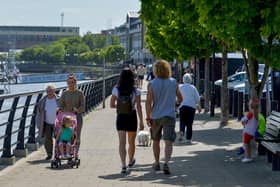 People enjoy a sunny spell along the Foyle Embankment back in 2022. DER2220GS - 014