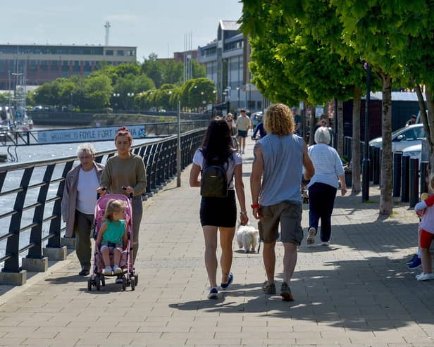 People enjoy a sunny spell along the Foyle Embankment back in 2022. DER2220GS - 014